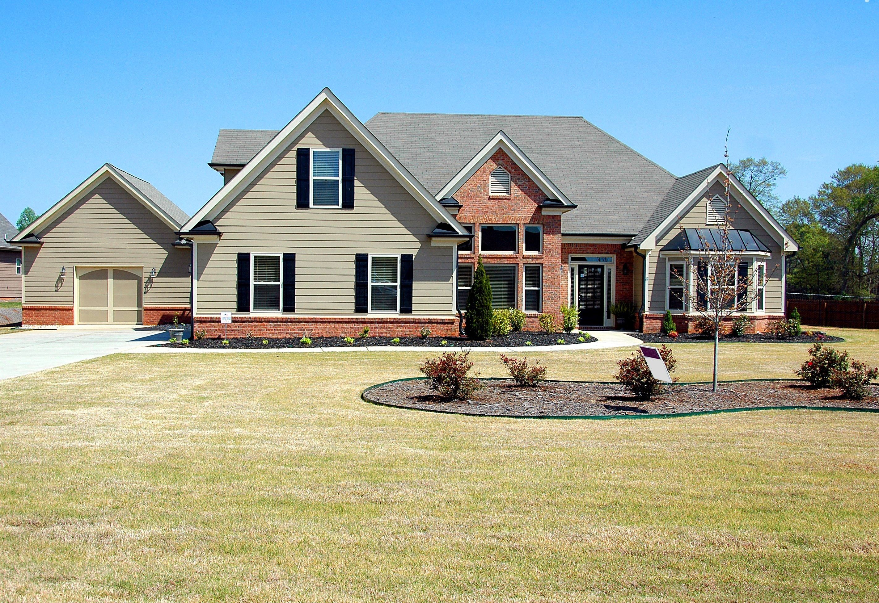 Home exterior with finished landscaping and driveway